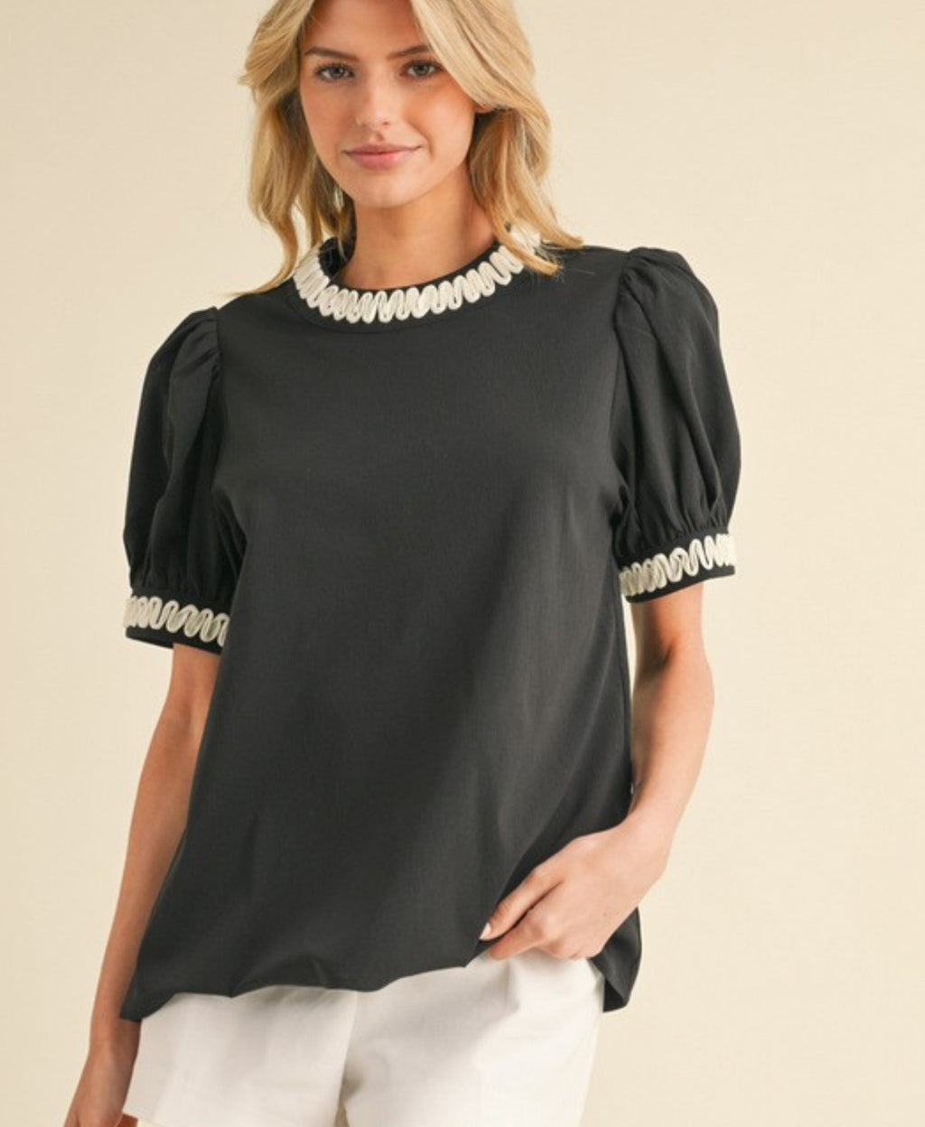 Black top trimmed in white with puff sleeves