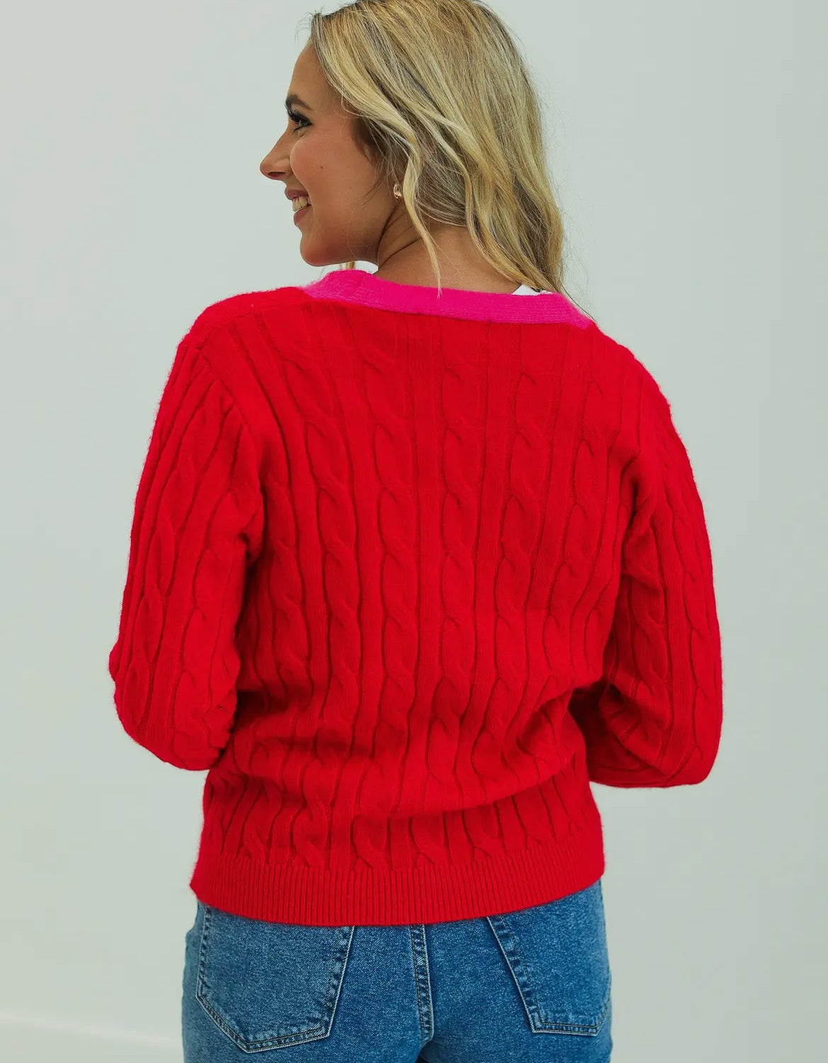 Red sequined xmas tree accented with pink cardigan