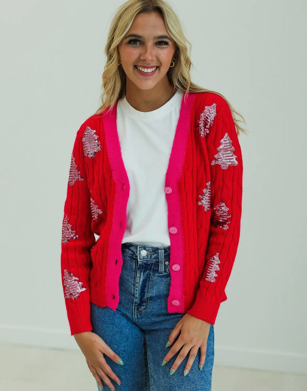 Red sequined xmas tree accented with pink cardigan