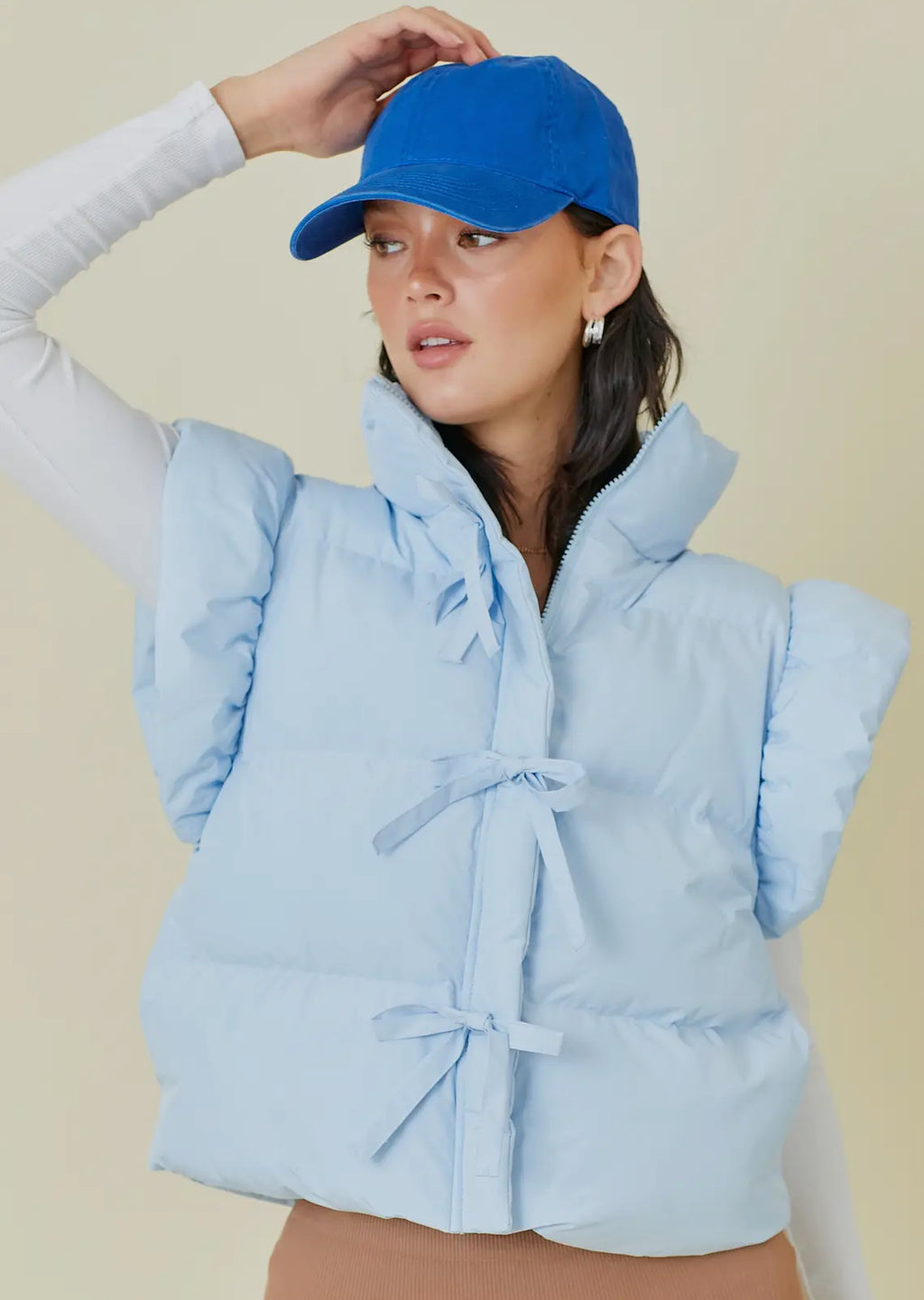 Baby blue puffer vest with bow detail w/ zipper and pockets