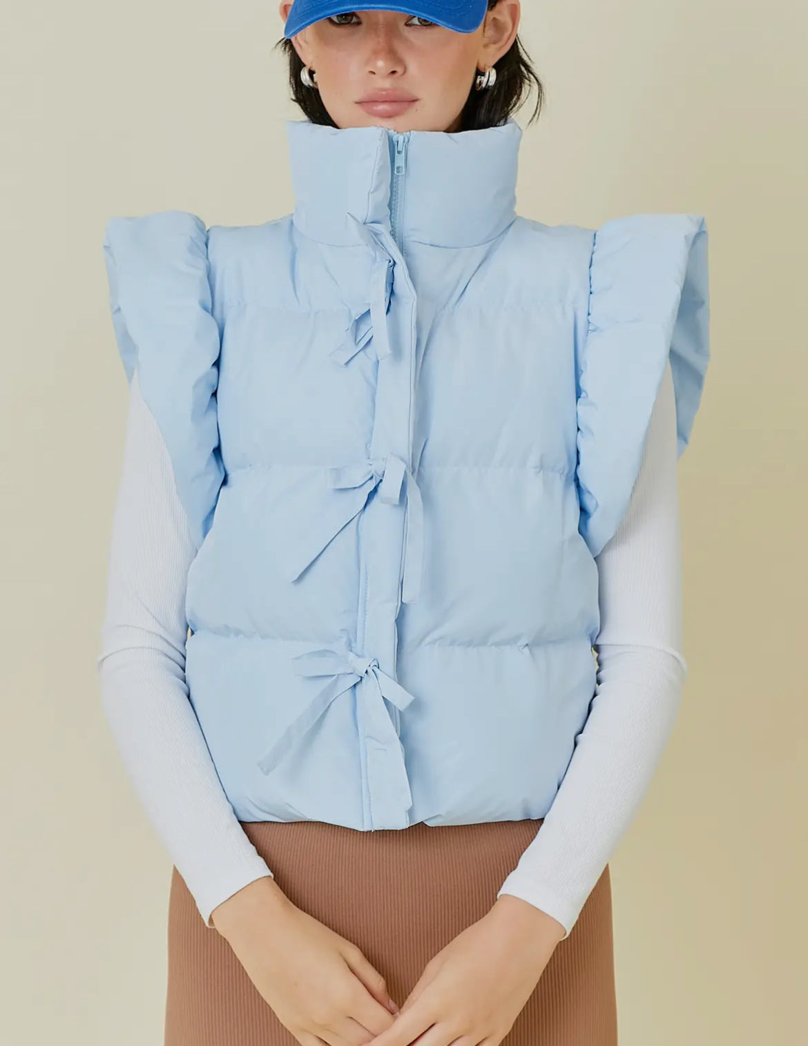 Baby blue puffer vest with bow detail w/ zipper and pockets