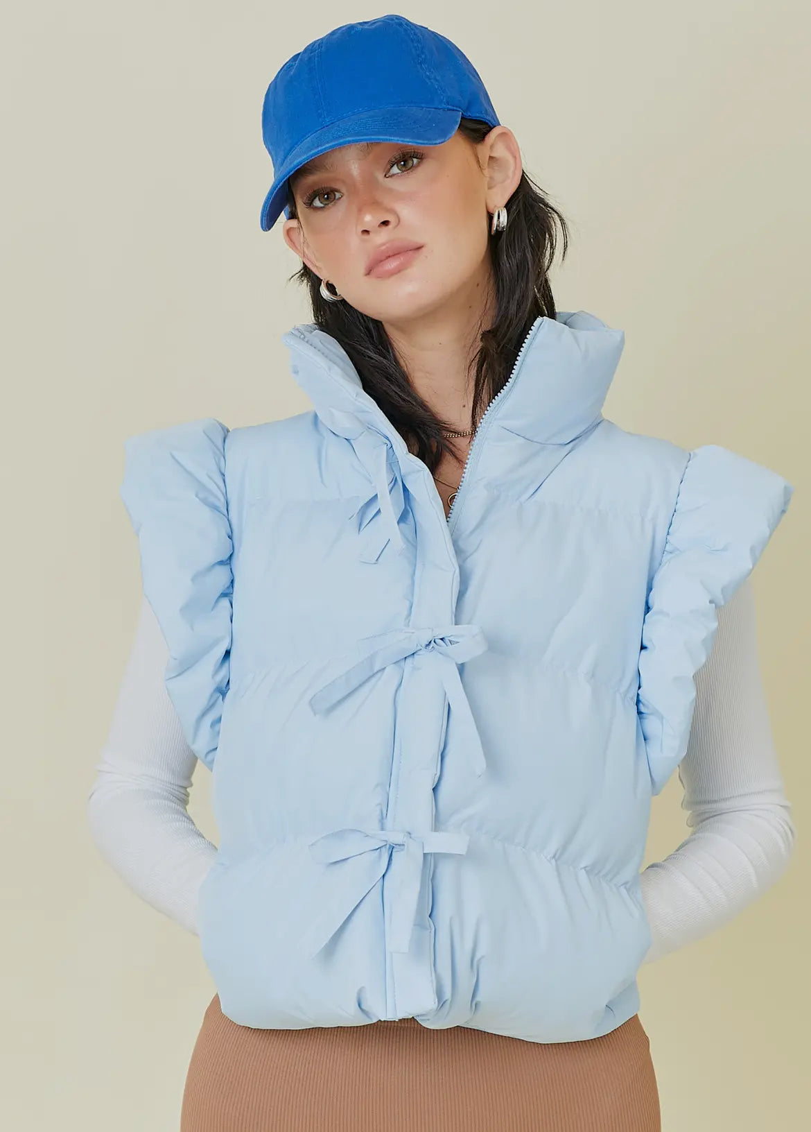 Baby blue puffer vest with bow detail w/ zipper and pockets