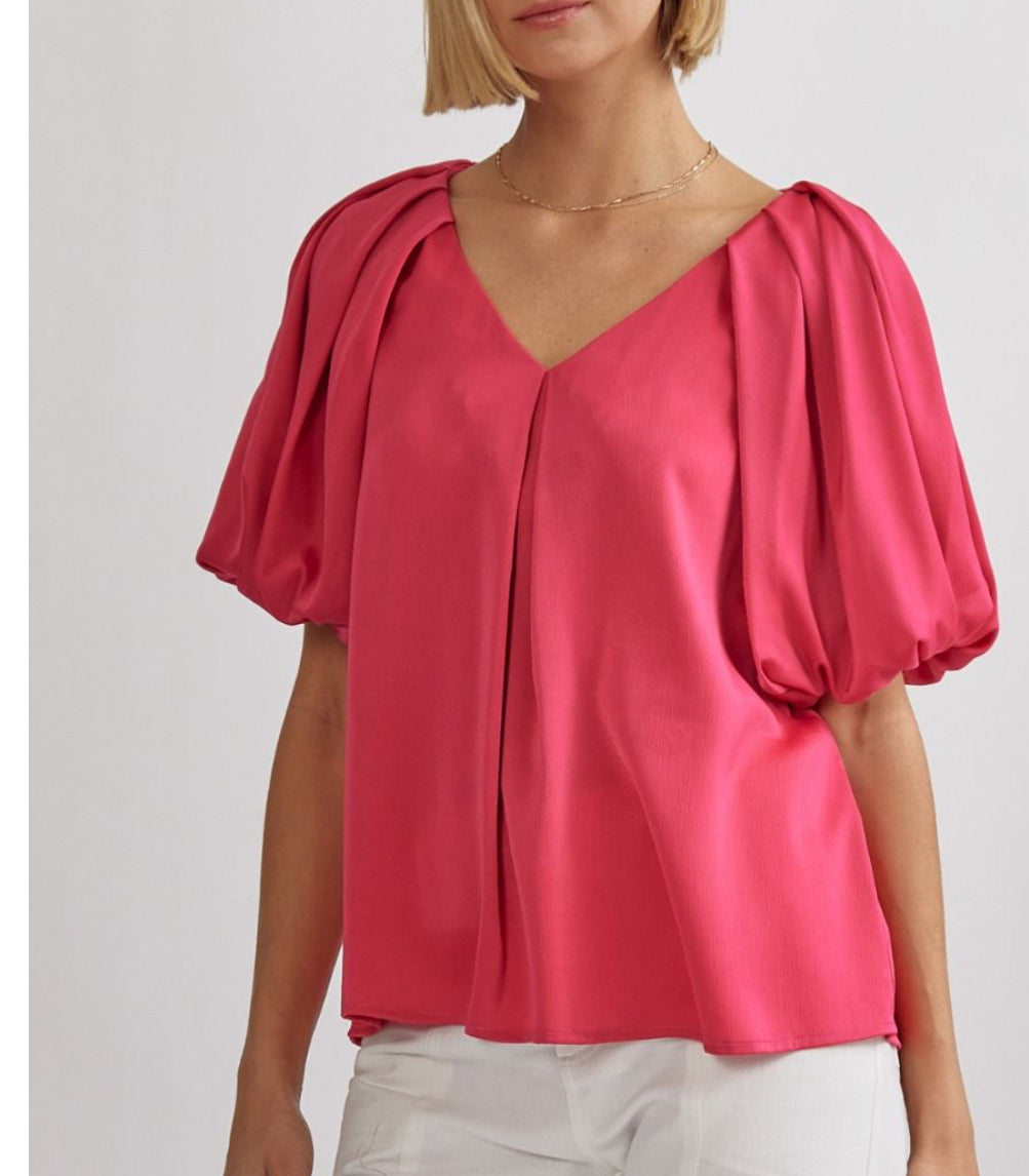 Hot pink satin v-neck bubble sleeve top featuring pleat details-lined